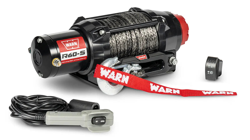 Warn R60-S powersports winch, three-quarter view on white, shown with the corded remote and dash-mounted control switch supplied with it