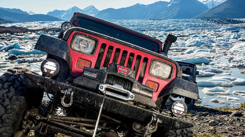 Warn ZEON Platinum 10-S Winch with synthetic rope mounted on a Jeep, winching off-road