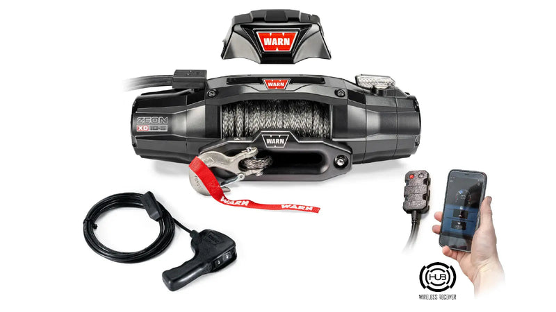 Warn ZEON XD 10-S winch shown with its control pack separated for relocation and the Warn HUB app running on a phone