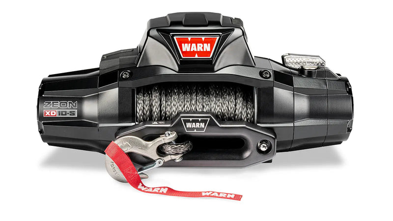 Warn ZEON XD 10-S winch, front three-quarter studio view with Spydura synthetic rope spooled and the red hook strap fitted