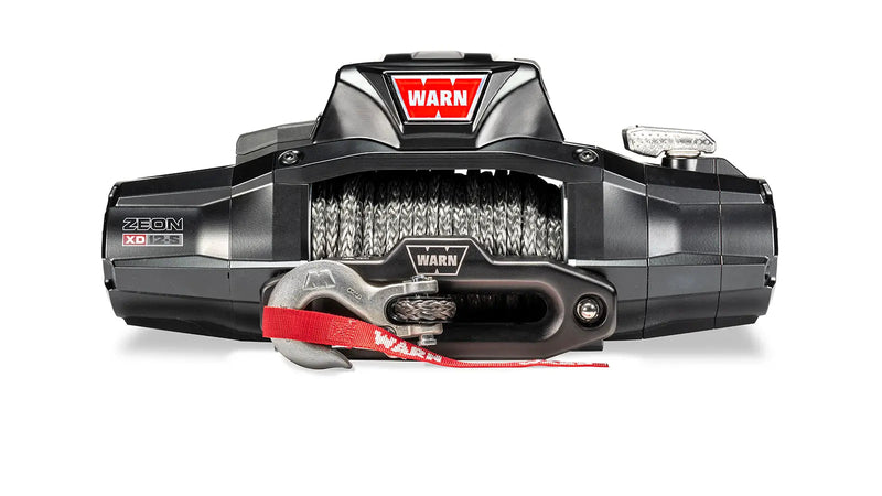 Warn ZEON XD 12-S winch, front three-quarter studio view with Spydura Pro synthetic rope spooled and the red hook strap fitted