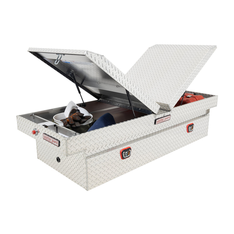 Weather Guard 114-0-04 gull-wing crossover box in bright aluminum diamond plate, staged open with hand tools inside to show how the usable space loads