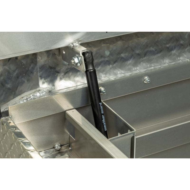 Weather Guard 117-0-04 crossover saddle box in bright aluminum diamond plate, close-up of the gas strut holding the lid open