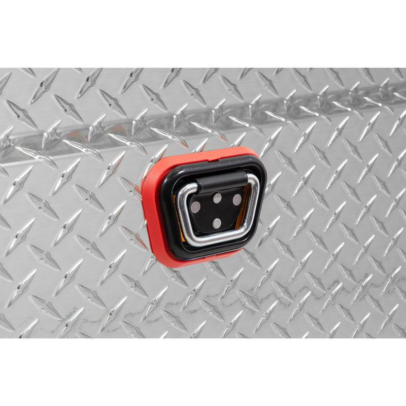 Weather Guard 117-0-04 crossover saddle box in bright aluminum diamond plate, close-up of the reinforced tie-down buckle on the body