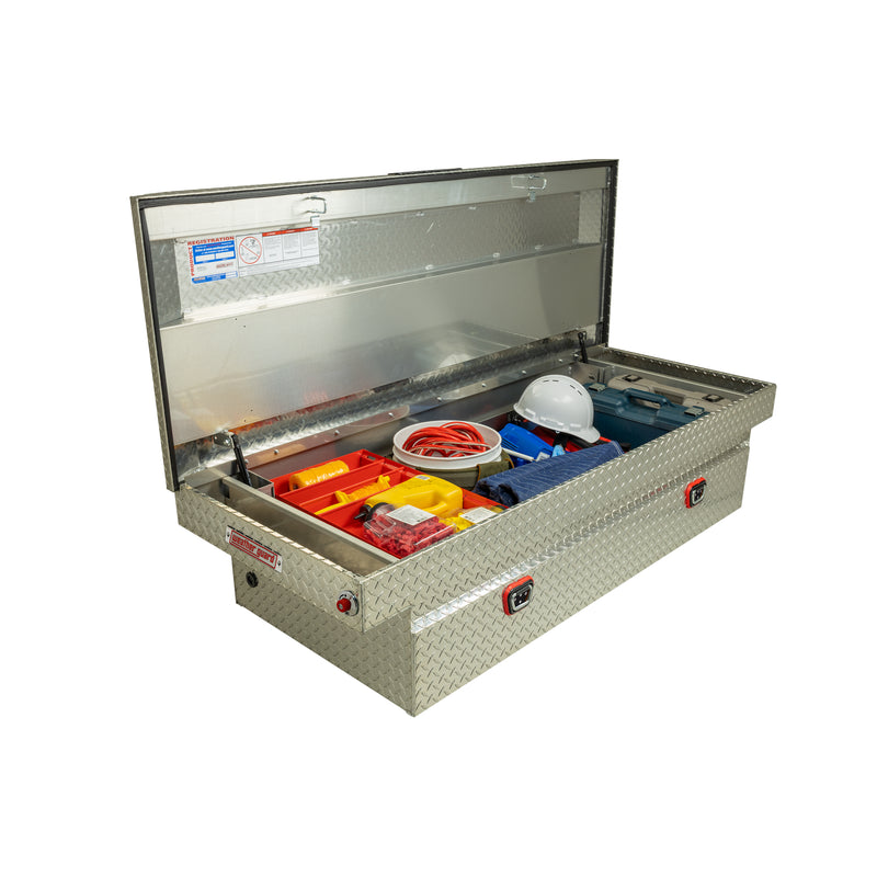 Weather Guard 117-0-04 crossover saddle box in bright aluminum diamond plate, staged open with hand tools inside to show how the usable space loads