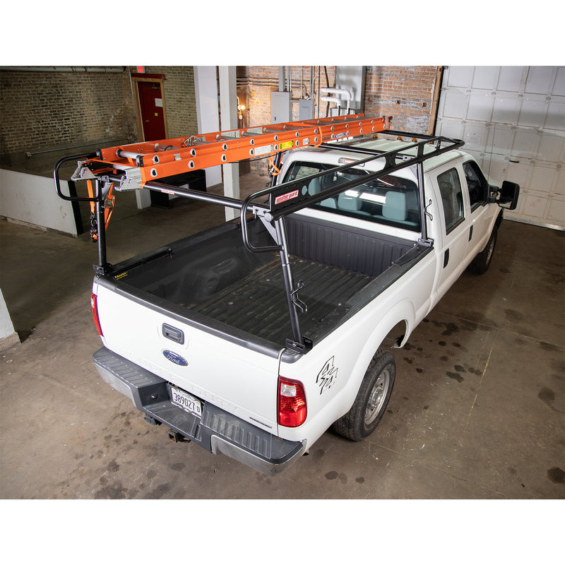 Orange extension ladder carried on the Weather Guard heavy-duty steel truck rack of a white pickup