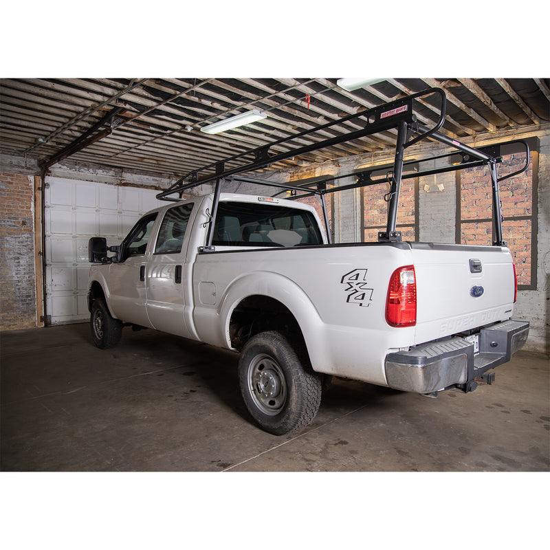 Side view of a white pickup fitted with the Weather Guard heavy-duty steel truck rack in a workshop
