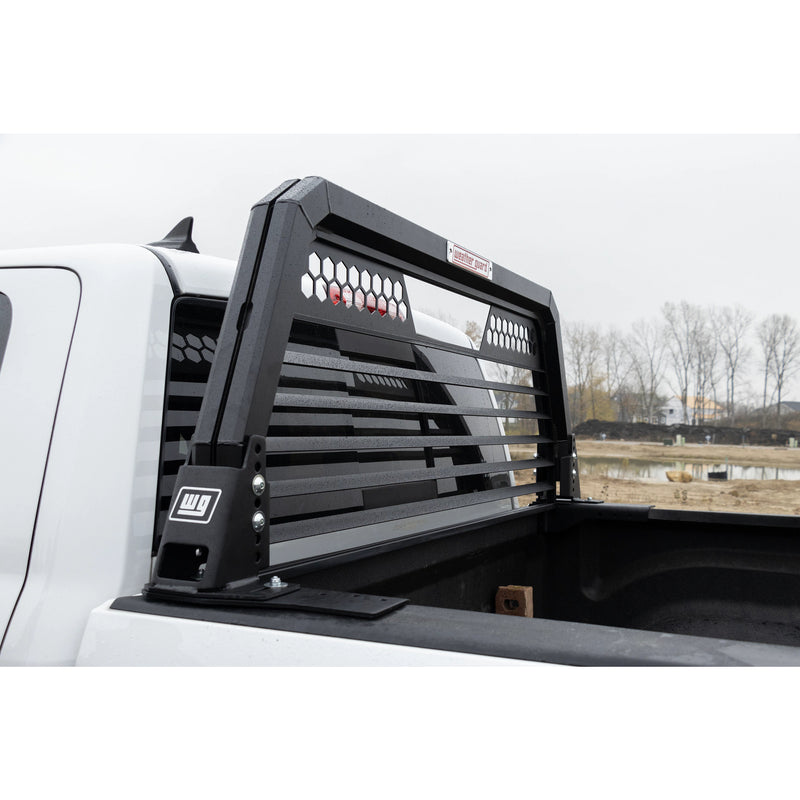 Weather Guard louvered headache rack mounted on the bed rails of a white pickup, seen from the bed