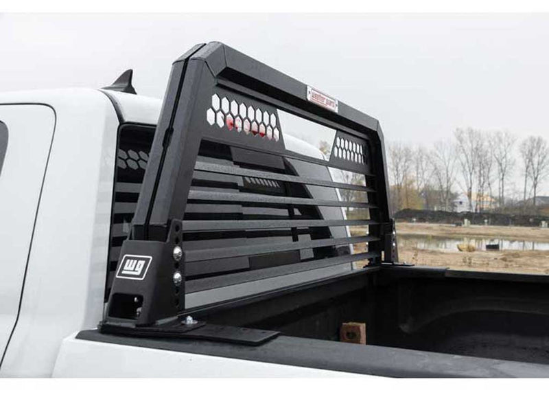 Louvered Weather Guard headache rack standing against the cab of a white Ram pickup seen from the side of the bed