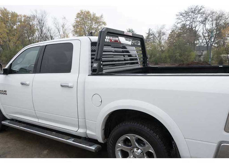 Full side profile of a white Ram pickup fitted with the Weather Guard louvered headache rack