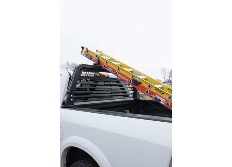 Ladder secured over the cab on the Weather Guard louvered headache rack of a white pickup
