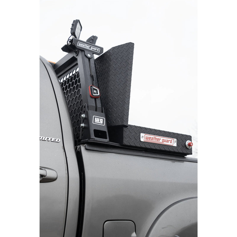 Close-up of the Weather Guard hex headache rack upright, work light and the crossover box beside it