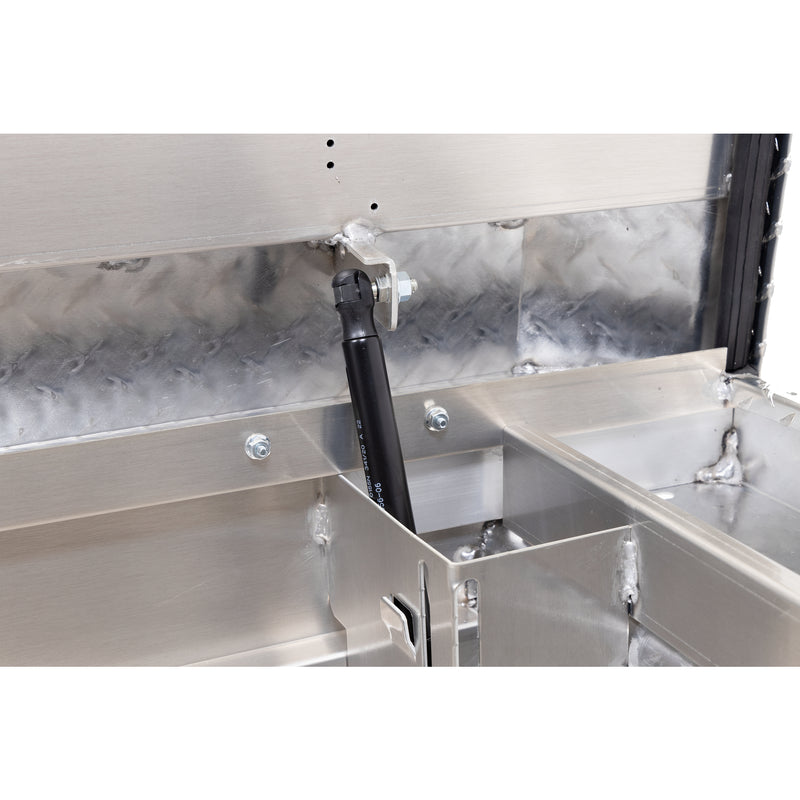 Weather Guard 121-0-04 crossover saddle box in bright aluminum diamond plate, close-up of the gas strut holding the lid open