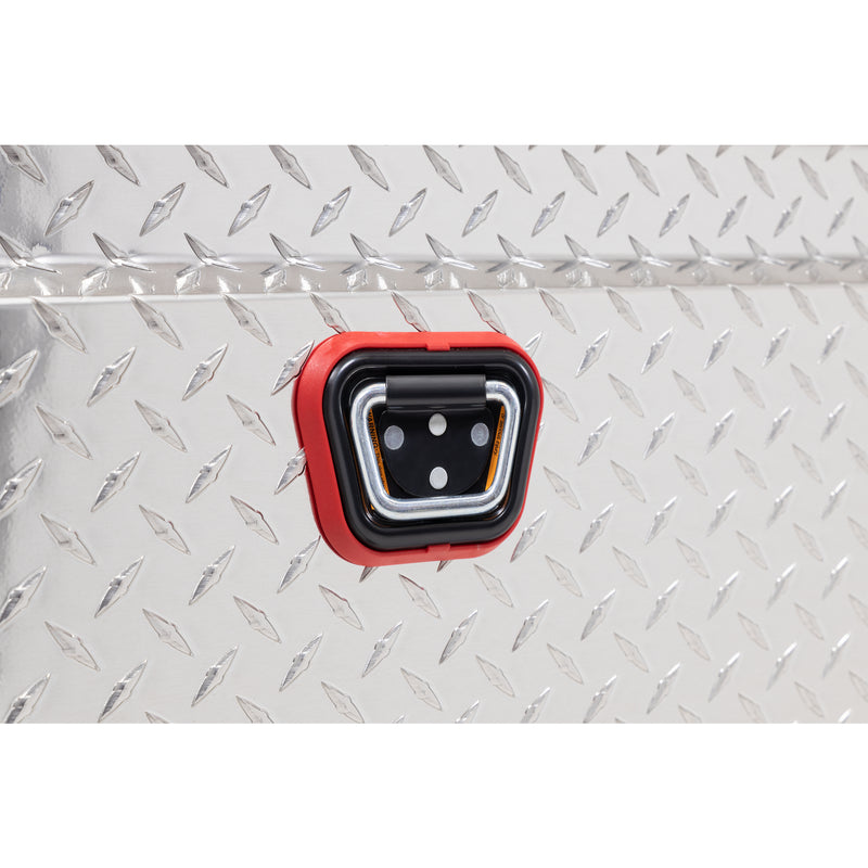 Weather Guard 121-0-04 crossover saddle box in bright aluminum diamond plate, close-up of the reinforced tie-down buckle on the body