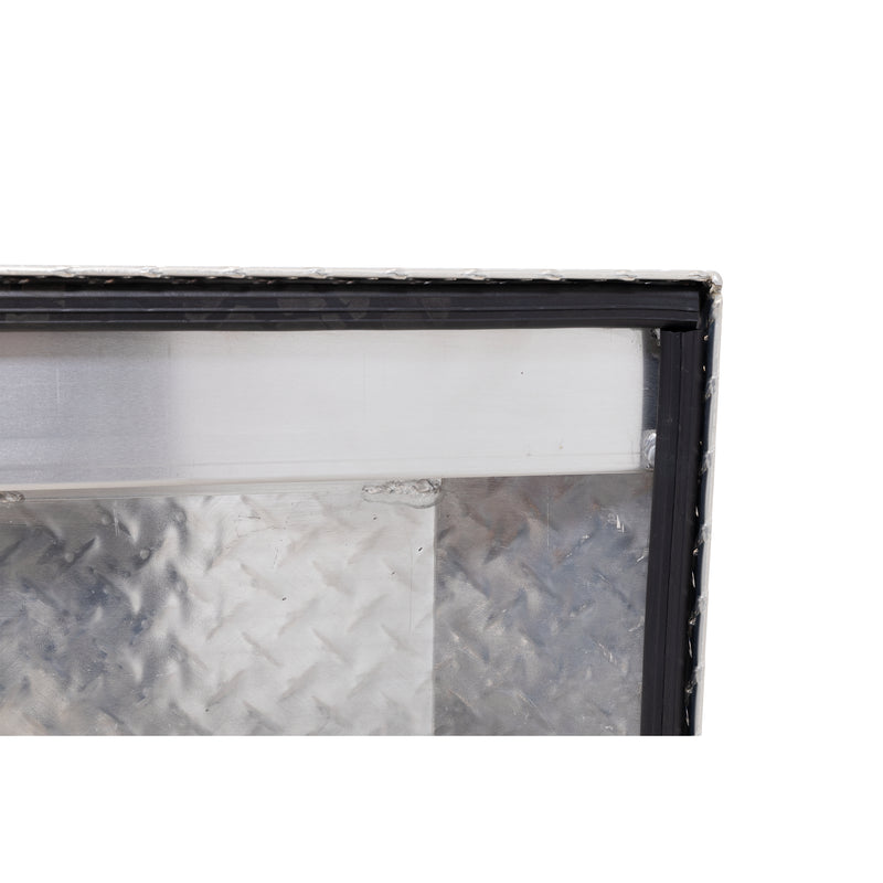 Weather Guard 123-0-04 crossover saddle box in bright aluminum diamond plate, close-up of the D-shaped ribbed weather seal around the opening
