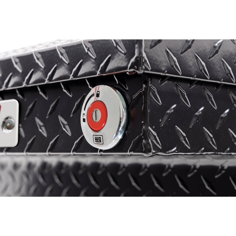 Weather Guard 123-5-04 crossover saddle box in gloss black, close-up of the red push-button lock and Weather Guard badge