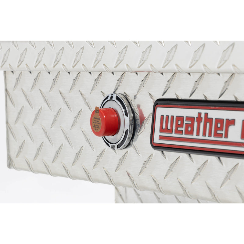Weather Guard 124-0-04 gull-wing crossover box in bright aluminum diamond plate, close-up of the red push-button lock and Weather Guard badge