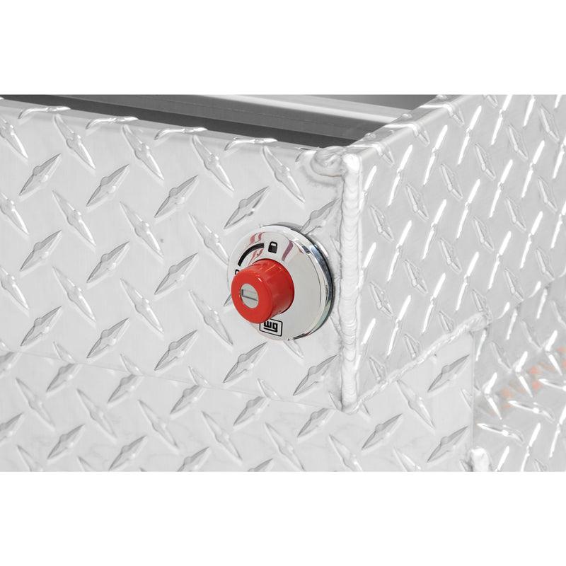 Weather Guard 127-0-04 crossover saddle box in bright aluminum diamond plate, close-up of the red push-button lock and Weather Guard badge