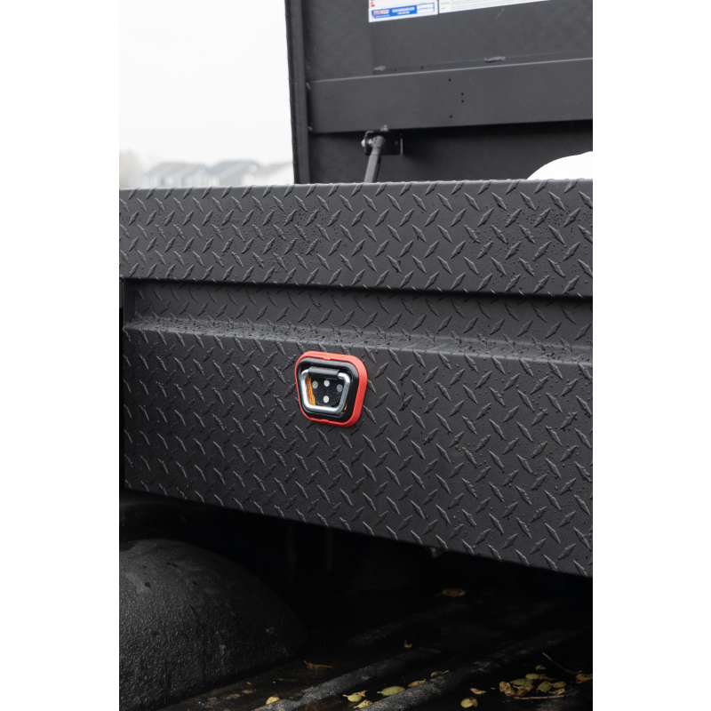 Close-up of the red-bezel 1Key UltraLock push-button lock on the matte black diamond-plate Weather Guard 127-52-04 box, installed on a truck