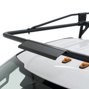 Close-up of the Weather Guard truck rack front airfoil crossbar arching over the cab roof of a white pickup