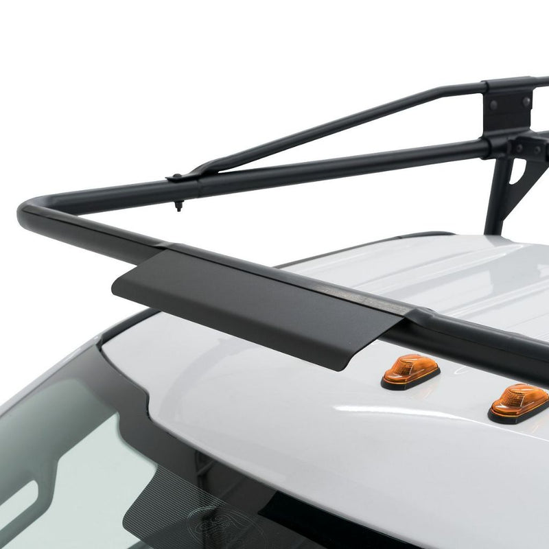 Close-up of the Weather Guard truck rack front airfoil crossbar arching over the cab roof of a white pickup