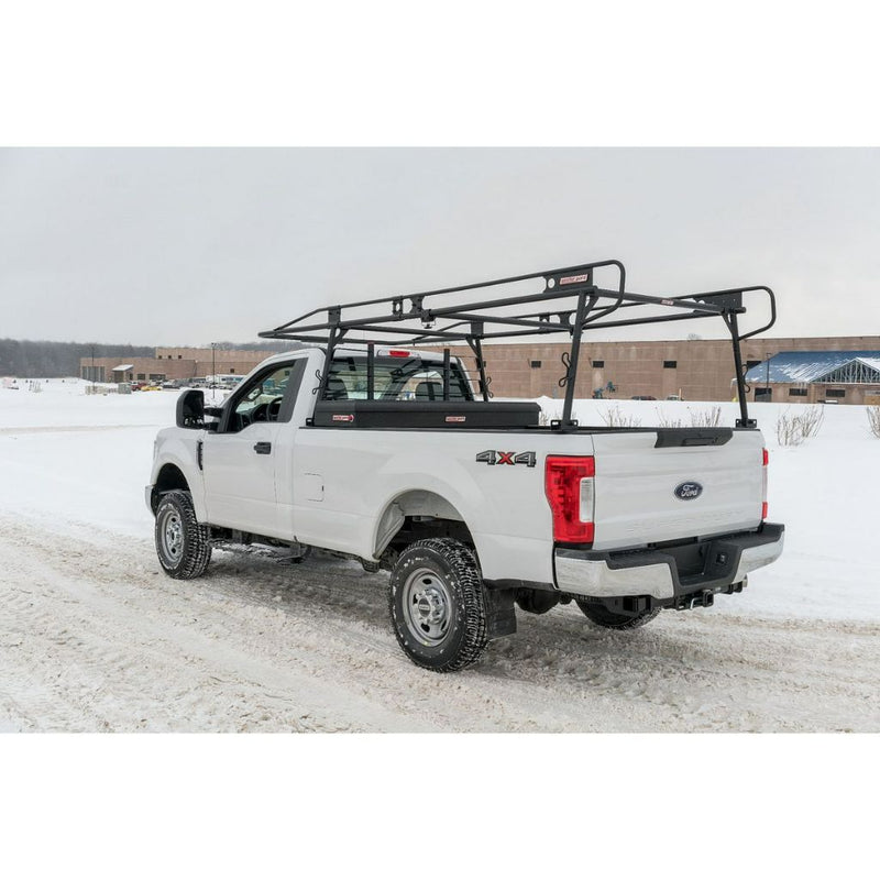 Weather Guard full-size steel truck rack and crossover box on a white Ford Super Duty parked at a snowy jobsite
