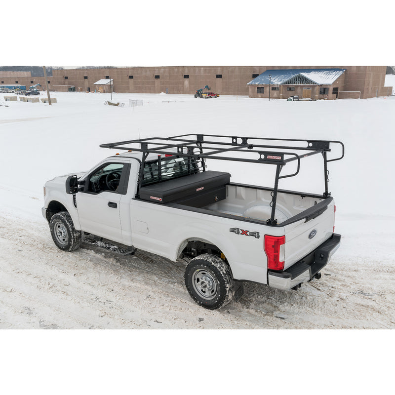 White pickup with the Weather Guard 1275 steel truck rack parked at a snowy construction site, left side view