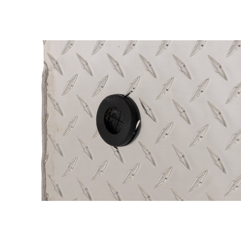 Weather Guard 131-0-04 crossover saddle box in bright aluminum diamond plate, close-up of the 12 volt power pass access port grommet