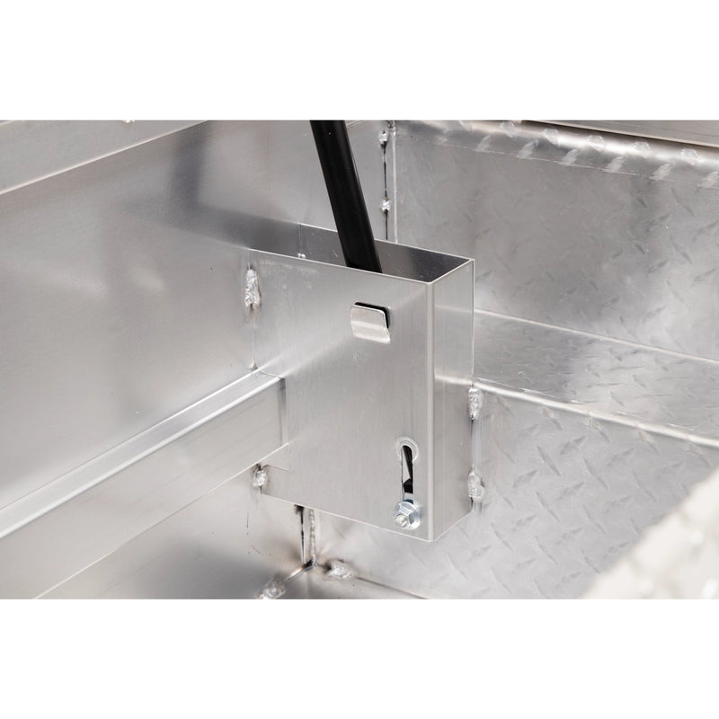Weather Guard 131-0-04 crossover saddle box in bright aluminum diamond plate, close-up of the welded gas strut shield inside the body