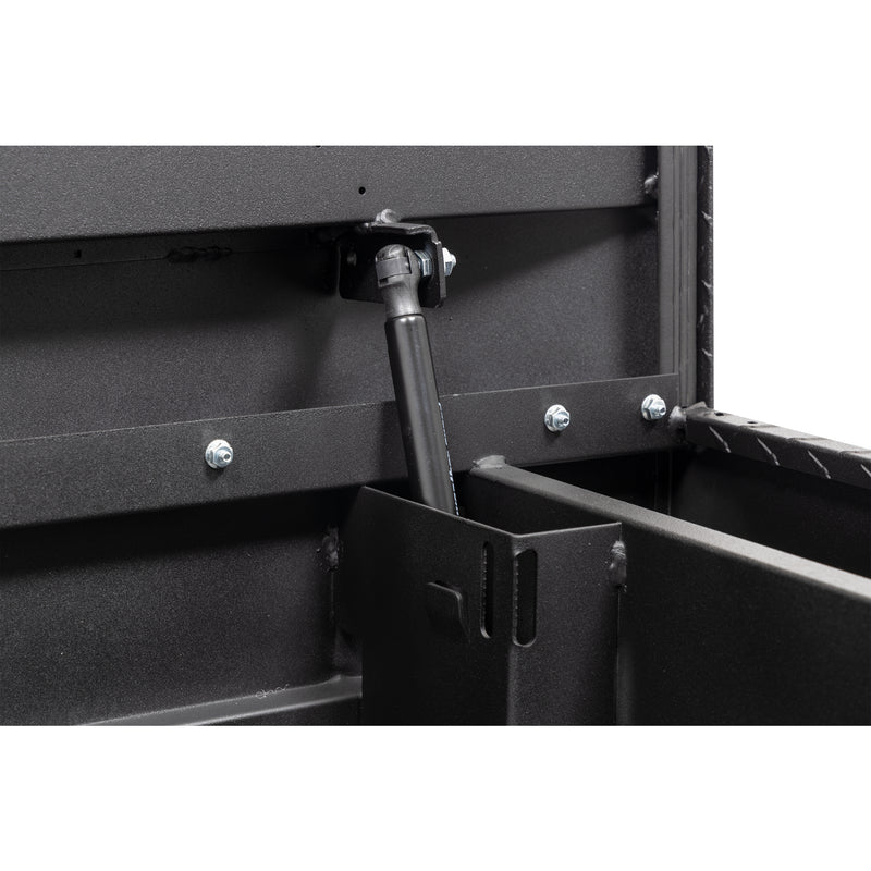 Weather Guard 137-52-04 crossover saddle box in textured matte black, close-up of the gas strut holding the lid open