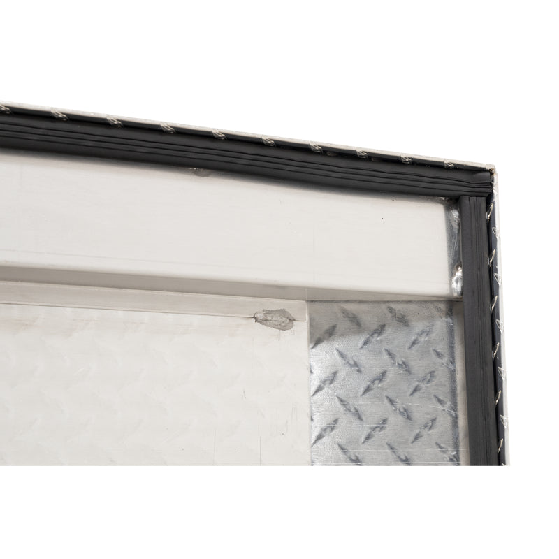 Weather Guard 154-0-04 crossover saddle box in bright aluminum diamond plate, close-up of the D-shaped ribbed weather seal around the opening