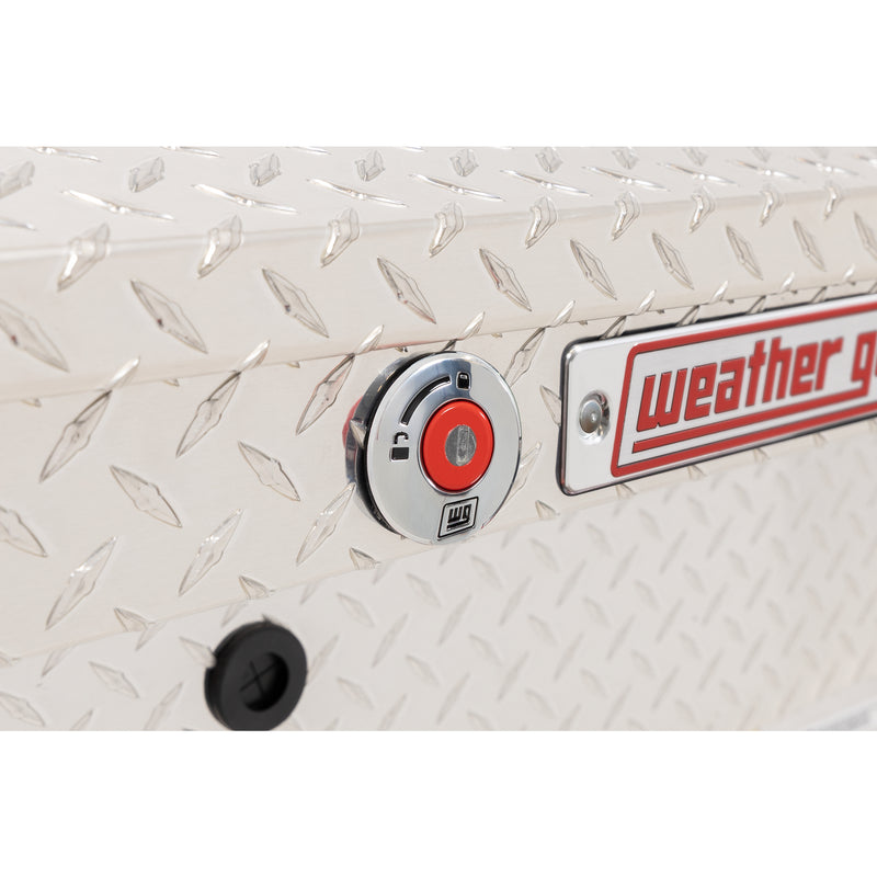 Weather Guard 164-0-04 Lo-Side box in bright aluminum diamond plate, close-up of the red push-button lock and Weather Guard badge