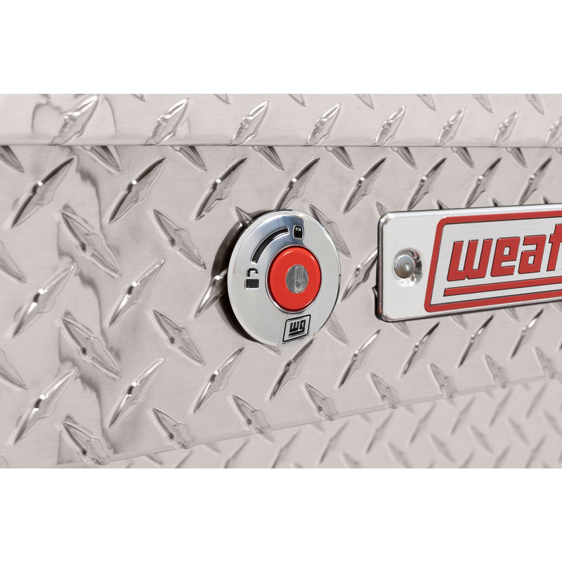 Weather Guard 174-0-04 Lo-Side box in bright aluminum diamond plate, close-up of the red push-button lock and Weather Guard badge
