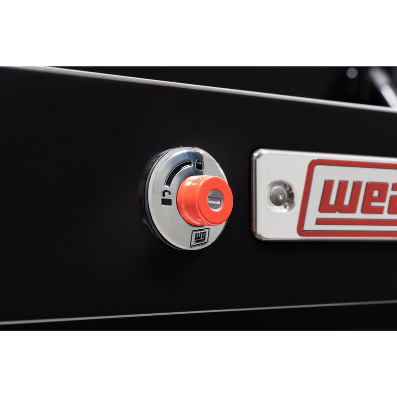 Weather Guard 175-5-04 Lo-Side box in gloss black, close-up of the red push-button lock and Weather Guard badge