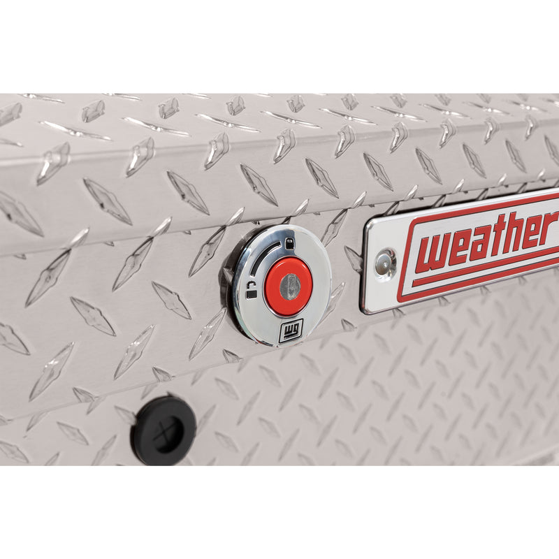 Weather Guard 180-0-04 low-profile Lo-Side box in bright aluminum diamond plate, close-up of the red push-button lock and Weather Guard badge