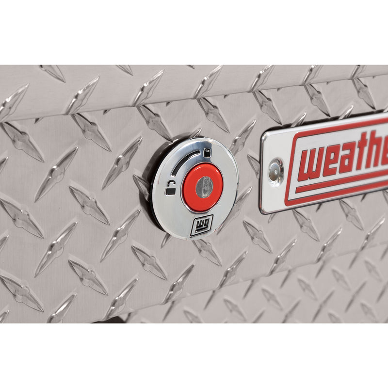 Weather Guard 184-0-04 Lo-Side box in bright aluminum diamond plate, close-up of the red push-button lock and Weather Guard badge