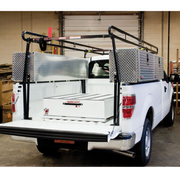 Weather Guard Pack Rat drawer unit installed in a white pickup bed alongside a steel truck rack and aluminum crossover boxes