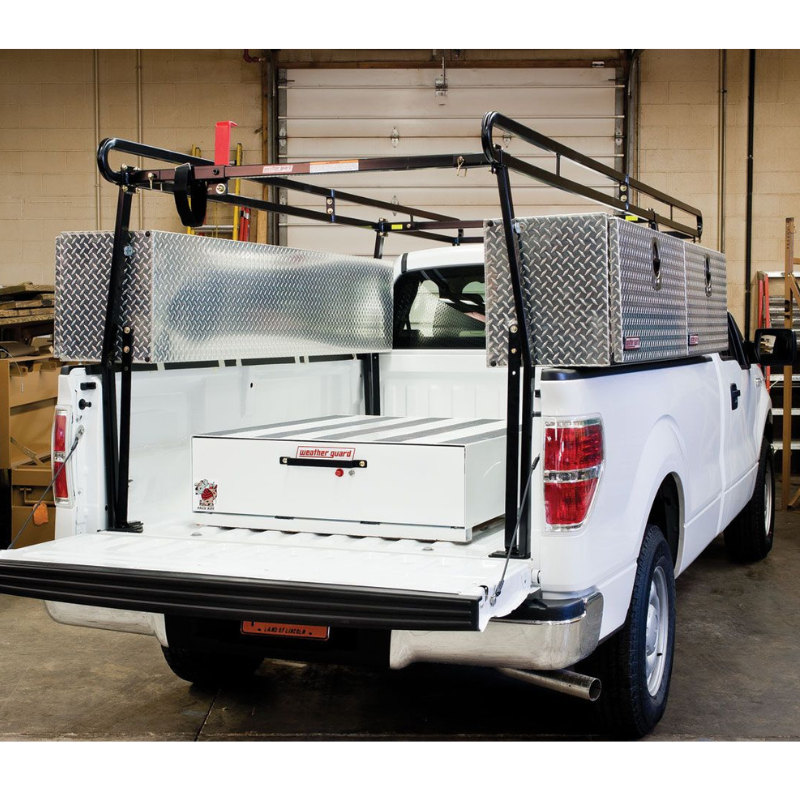 Weather Guard Pack Rat drawer unit installed in a white pickup bed alongside a steel truck rack and aluminum crossover boxes