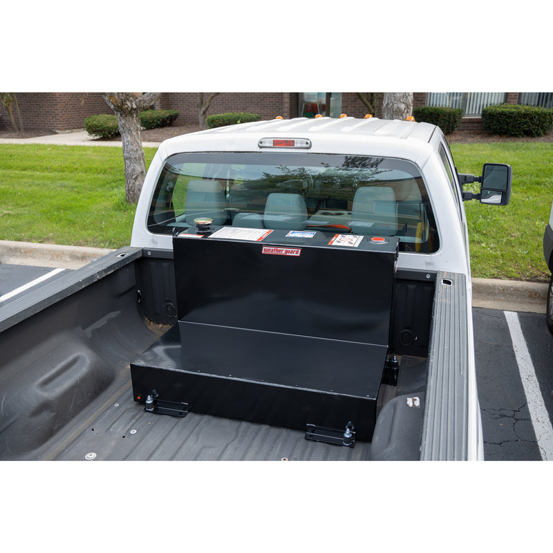 Wide view of the gloss black 75 gallon Weather Guard tank mounted in a pickup bed with the tailgate down