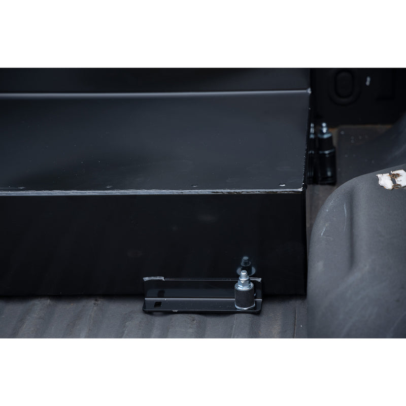 Close-up of a Weather Guard transfer tank mounting foot bolted down to the pickup bed floor