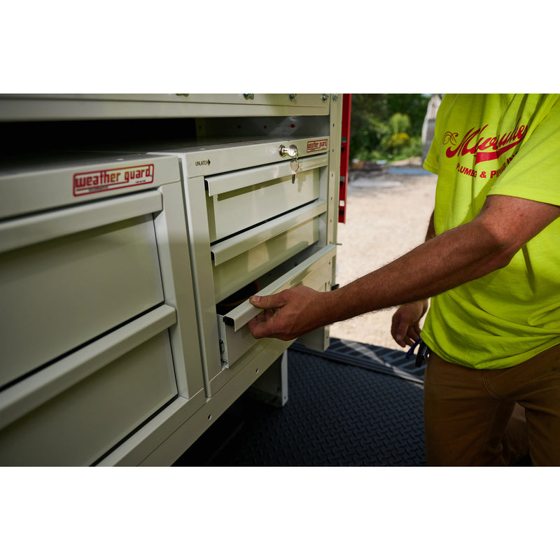 Weather Guard 903-3-01 Secure Storage 3-Drawer Module, a technician pulling a drawer open on a truck-mounted secure storage module