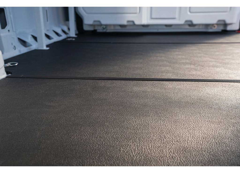 Close view of the flat non-slip rubberized surface of the Weather Guard rigid floor in a Ford Transit