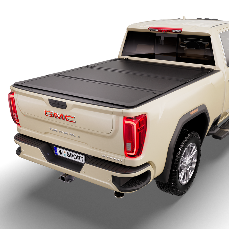 Worksport NEXUS hard folding tonneau cover on a pickup: studio render of a tan GMC Sierra Denali from the rear quarter with a black NEXUS hard folding tonneau cover closed