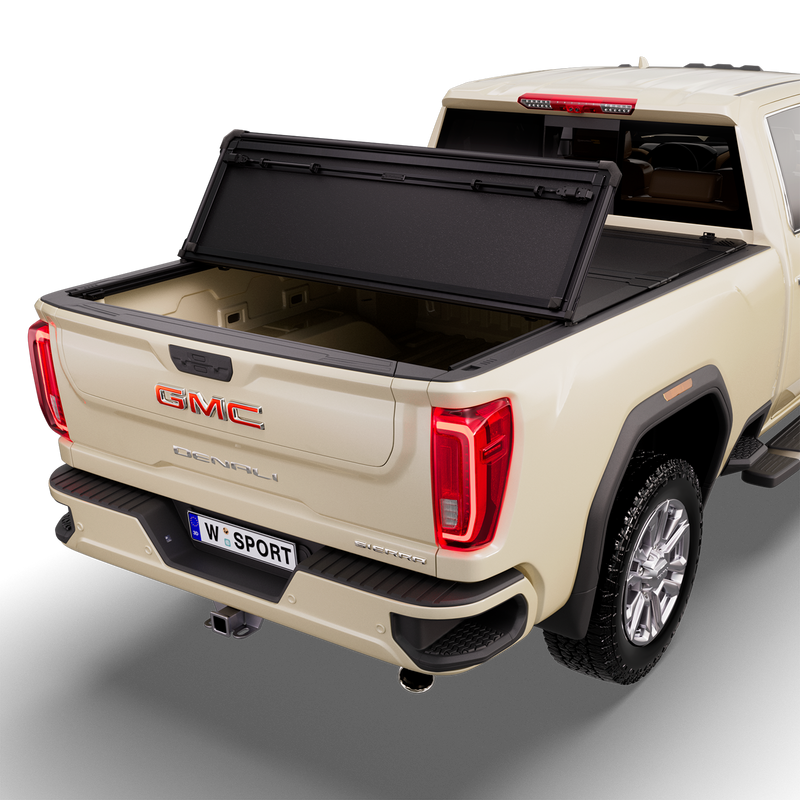 Worksport NEXUS hard folding tonneau cover on a pickup: studio render of a tan GMC Sierra Denali from the rear quarter with a black NEXUS hard folding tonneau cover with the rear panel folded forward onto the middle panel