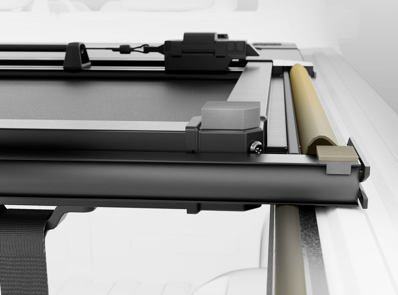 Close-up of the Worksport NEXUS hard folding tonneau cover: overhead close-up render of the NEXUS front corner showing the rail, clamp hardware and a latch box on a white truck bed