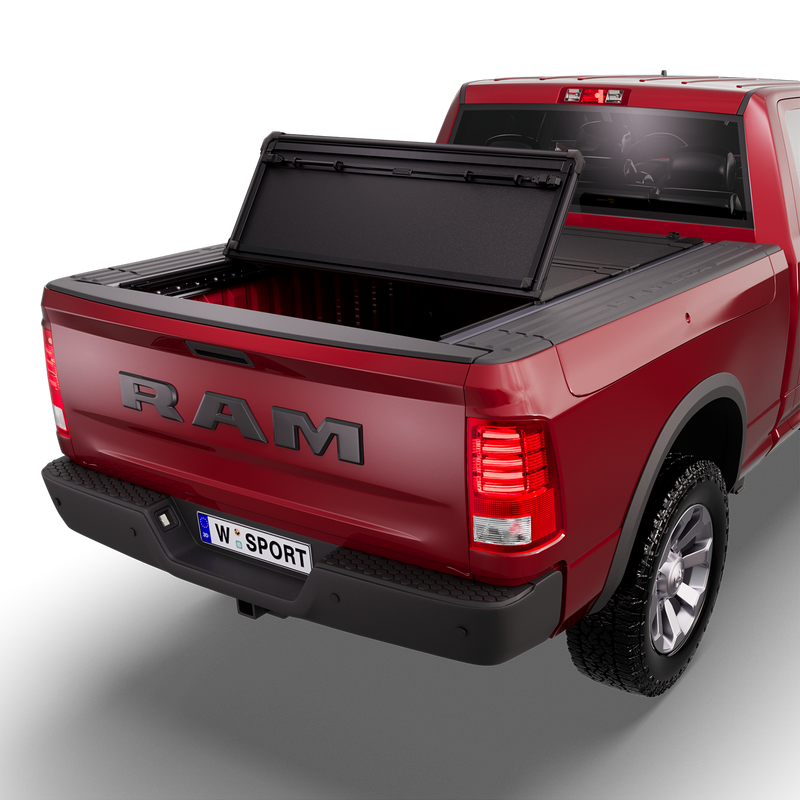 Worksport NEXUS hard folding tonneau cover shown on a 2013-18 Ram 1500 with RamBox, an older generation than the trucks this listing fits: studio render with the cover folded once, rear of the bed open