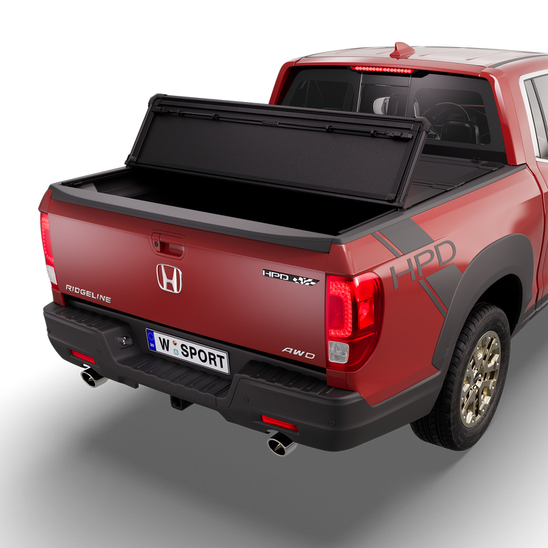 Worksport NEXUS hard folding tonneau cover on a pickup: 3D studio render of a red Honda Ridgeline from the rear quarter with a black NEXUS hard folding tonneau cover rear panel folded forward, one fold, rear of the bed open