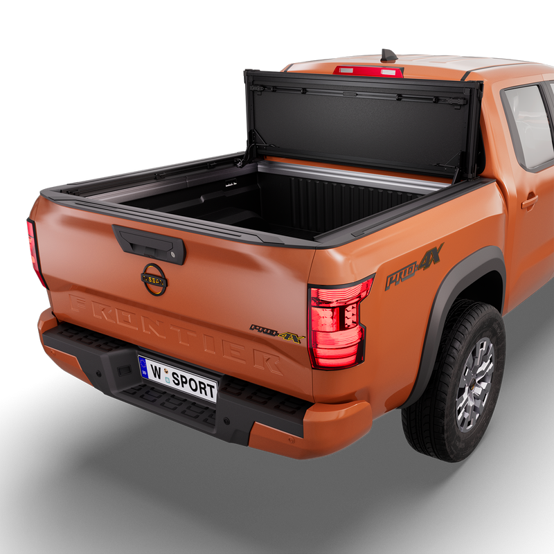 Worksport NEXUS hard folding tonneau cover on a pickup: 3D studio render of an orange Nissan Frontier from the rear quarter with a black NEXUS hard folding tonneau cover folded stack flipped up vertical against the cab, full bed open