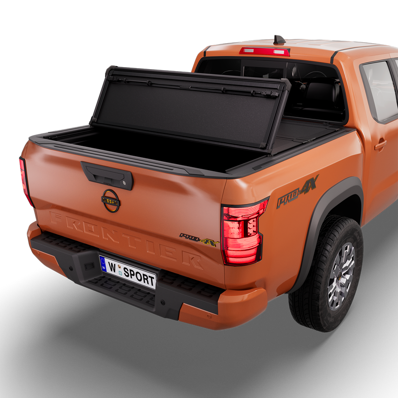 Worksport NEXUS hard folding tonneau cover on a pickup: 3D studio render of an orange Nissan Frontier from the rear quarter with a black NEXUS hard folding tonneau cover rear panel folded forward, one fold, rear of the bed open