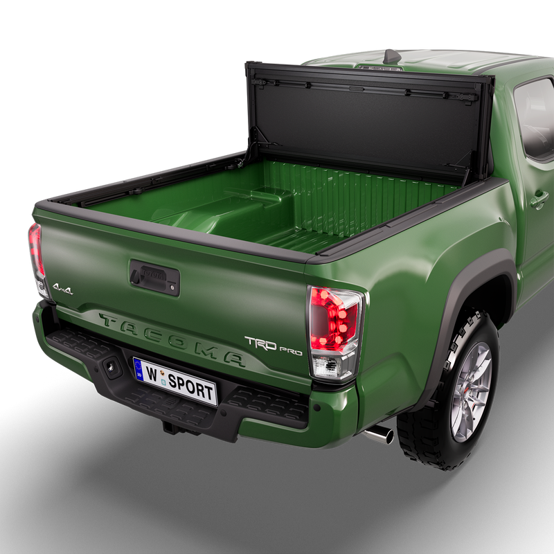 Worksport NEXUS hard folding tonneau cover on a pickup: studio render of a green third-generation Toyota Tacoma TRD Pro from the rear quarter with a black NEXUS hard folding tonneau cover flipped up vertical against the cab, bed fully open